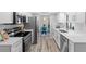 Modern white kitchen with stainless steel appliances and view to adjacent dining area at 1217 Carmella Ln, Sarasota, FL 34243