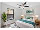 Bedroom featuring a king-sized bed, ceiling fan, and a bright window at 1217 Carmella Ln, Sarasota, FL 34243