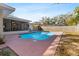 Backyard pool with a view of the screened patio and partially fenced yard at 1217 Carmella Ln, Sarasota, FL 34243