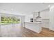 Bright and airy living room with hardwood floors, an open layout, and sliding glass doors to the outdoors at 1219 Kazaz Ct, Zephyrhills, FL 33540