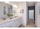 Modern bathroom with double sinks, white cabinets, and tiled floors at 1231 Kazaz Ct, Zephyrhills, FL 33540