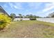 Grass backyard with a white vinyl fence at 12705 Bramfield Dr, Riverview, FL 33579