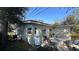 Outdoor patio space featuring a table and chairs, propane tank, and some other house utilities at 13634 Twig Ter, Largo, FL 33774