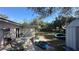 Backyard patio with outdoor furniture, grill, and access to the yard; some items are scattered at 13634 Twig Ter, Largo, FL 33774