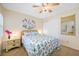 Bedroom with queen bed, nightstand and large mirror at 14130 Rosemary Ln # 3204, Largo, FL 33774