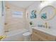 Updated bathroom with beige tile, gold fixtures, and a stylish vanity at 1418 Barry St, Clearwater, FL 33756