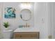 Modern bathroom features a stylish vanity with gold fixtures and a large mirror at 1418 Barry St, Clearwater, FL 33756