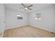 Bright bedroom with ceiling fan, light flooring, and ample closet space at 1418 Barry St, Clearwater, FL 33756