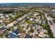 Aerial view of a residential neighborhood showcasing tree-lined streets and various single-Gathering homes at 14607 Turning Leaf Ct, Tampa, FL 33626