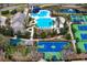 Aerial view featuring a community playground, basketball court, swimming pool, and clubhouse at 14607 Turning Leaf Ct, Tampa, FL 33626