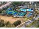 Aerial view of a community including tennis courts, pool, and clubhouse at 14607 Turning Leaf Ct, Tampa, FL 33626