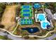 Aerial view of community amenities including swimming pool, tennis courts, basketball court, and pond at 14607 Turning Leaf Ct, Tampa, FL 33626