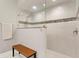 Modern bathroom featuring a glass-enclosed shower with tile accents and a wooden bench at 14607 Turning Leaf Ct, Tampa, FL 33626