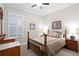 Bedroom featuring bed, window with shutters, ceiling fan, and two bedside tables at 14607 Turning Leaf Ct, Tampa, FL 33626