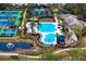 Aerial view of a community pool with slides, lounge chairs, and lush landscaping at 14607 Turning Leaf Ct, Tampa, FL 33626