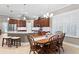 Dining area with kitchen view showcasing stainless appliances, island, and white tile backsplash at 14607 Turning Leaf Ct, Tampa, FL 33626