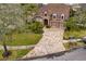 Aerial view of a two-story home featuring a three car garage and a brick paved driveway at 14607 Turning Leaf Ct, Tampa, FL 33626