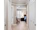 Bright hallway leading to bedroom with tray ceiling and wood floors at 14607 Turning Leaf Ct, Tampa, FL 33626