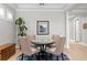 Elegant living room featuring stylish round table, column accents, and light wood floors at 14607 Turning Leaf Ct, Tampa, FL 33626