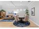 Comfortable living room features a round table with seating for four and plantation shutters at 14607 Turning Leaf Ct, Tampa, FL 33626