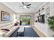 Bright living room with custom built-ins and sliding glass doors leading to outdoor patio at 14607 Turning Leaf Ct, Tampa, FL 33626