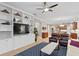 Comfortable living room showing built in entertainment unit, ceiling fan, and hardwood floors at 14607 Turning Leaf Ct, Tampa, FL 33626