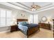 Spacious main bedroom with tray ceiling, ceiling fan, and shuttered windows at 14607 Turning Leaf Ct, Tampa, FL 33626