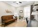 Home office featuring futon, lamp, ceiling fan, neutral colors and window with shutters at 14607 Turning Leaf Ct, Tampa, FL 33626