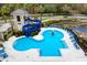 Aerial view of a fun community pool area with a water slide, lounge chairs, and landscaped surroundings at 14607 Turning Leaf Ct, Tampa, FL 33626