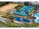 Aerial view of several tennis courts next to a pond with a fountain at 14607 Turning Leaf Ct, Tampa, FL 33626