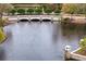 Stone bridge over a tranquil pond with fountains on a sunny day at 14607 Turning Leaf Ct, Tampa, FL 33626