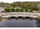 A peaceful water feature with a stone bridge and fountain in a tranquil setting at 14607 Turning Leaf Ct, Tampa, FL 33626