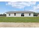 Backyard view of the home with fresh grass and a new roof at 15422 Wine Dr, Weeki Wachee, FL 34614