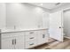 Bathroom featuring double sinks, white cabinets, and wood-look flooring at 15422 Wine Dr, Weeki Wachee, FL 34614