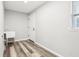 Laundry room featuring a utility sink and wood-look vinyl flooring at 15422 Wine Dr, Weeki Wachee, FL 34614