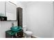 Modern bathroom with glass sink, dark vanity, and toilet at 156 29Th N Ave, St Petersburg, FL 33704