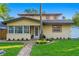 Two-story house with brick walkway, palm trees, and lush lawn at 156 29Th N Ave, St Petersburg, FL 33704