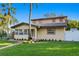 Two-story house with a well-manicured lawn and brick pathway at 156 29Th N Ave, St Petersburg, FL 33704