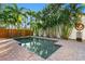 Inviting rectangular pool surrounded by a brick patio and tropical plants at 156 29Th N Ave, St Petersburg, FL 33704