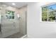 Updated shower with glass enclosure, patterned tile floor and window at 156 29Th N Ave, St Petersburg, FL 33704