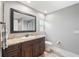 Bathroom with wood-look flooring, dark wood vanity, granite countertops and recessed lighting at 16908 Equestrian Trl, Odessa, FL 33556