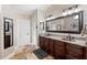 Elegant bathroom with double vanity and granite countertops at 16908 Equestrian Trl, Odessa, FL 33556