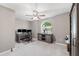 Neutral bedroom designed as office with gray walls, carpet, ceiling fan and unique arched window at 16908 Equestrian Trl, Odessa, FL 33556