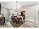 Elegant dining room features wood-look tile, modern lighting, and sliding doors to the lanai at 16908 Equestrian Trl, Odessa, FL 33556