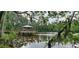 Picturesque gazebo on a lake offering a peaceful retreat surrounded by natural beauty at 16908 Equestrian Trl, Odessa, FL 33556