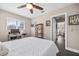 This bedroom features a ceiling fan, wood-look flooring, and a natural wood desk for getting work done at 1745 Emerald Dr, Clearwater, FL 33756