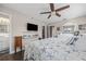 This bedroom features a ceiling fan, wood-look flooring, and a closet for ample storage at 1745 Emerald Dr, Clearwater, FL 33756