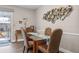 Inviting dining area with a glass top table and wicker chairs, near the sliding door leading to the patio at 1745 Emerald Dr, Clearwater, FL 33756