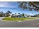 Corner lot featuring a well-maintained lawn and charming single-story home with mature trees at 1745 Emerald Dr, Clearwater, FL 33756