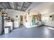 A spacious garage featuring epoxy floors, a laundry area with a washing machine, and an organization system at 1745 Emerald Dr, Clearwater, FL 33756